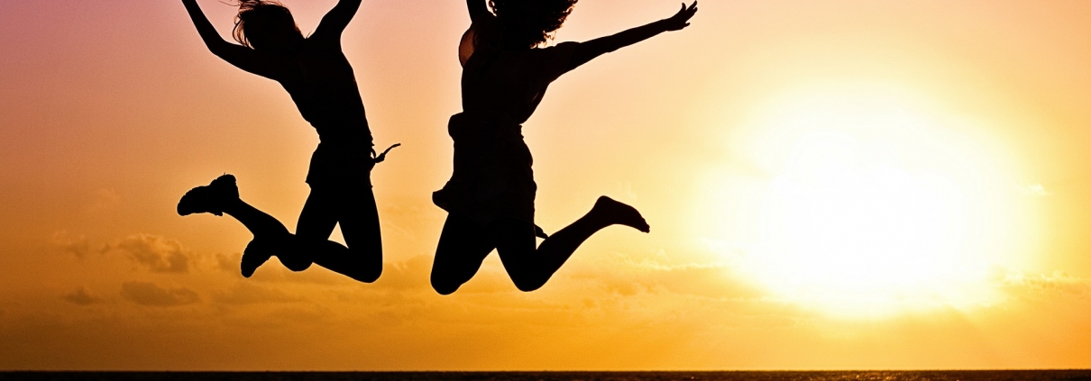 Two people jumping in the air