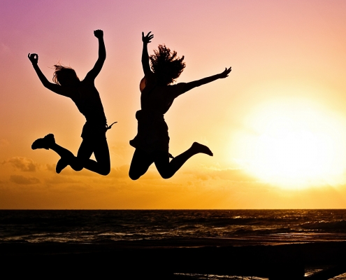 Two people jumping in the air
